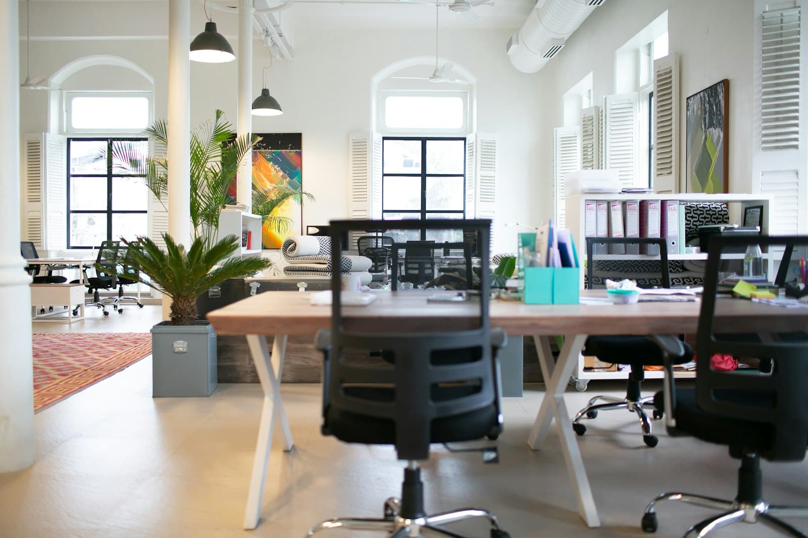 Packed moving boxes and desks in a modern office ready for an NYC commercial move